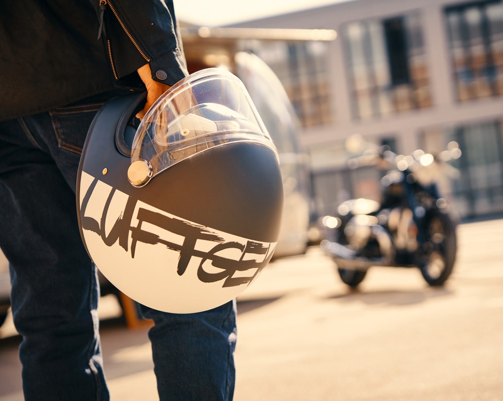 Person holding a motorcycle helmet